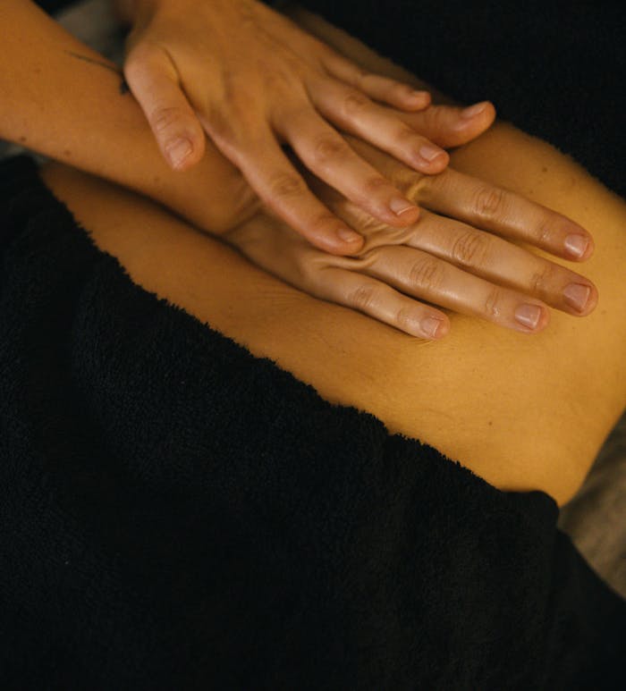 Hands providing a soothing massage, emphasizing relaxation and wellness in a spa environment.